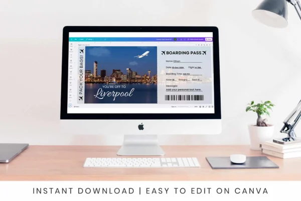 Liverpool Travel Ticket Bp 357 Feature Images 5 A computer screen displaying a canva interface with a liverpool-themed boarding pass being edited. The scene is set on a clean wooden desk with a white lamp, a plant, and stacked books, emphasizing the user-friendly and professional design process.