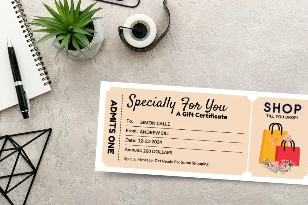A beige gift certificate with a shopping-themed design placed on a textured desk alongside a notepad, pen, and a potted plant.